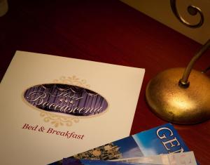 a sign for a bed and breakfast next to a apple at Hotel Boccascena in Genoa