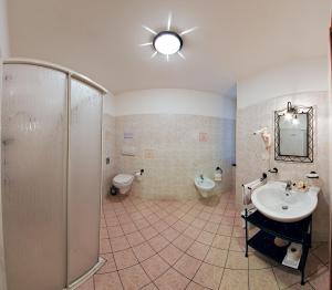 a bathroom with a shower and a sink and a toilet at Hotel Boccascena in Genoa