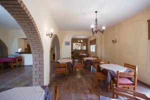 a dining room with tables and chairs in a building at Marie Hotel in Acharavi