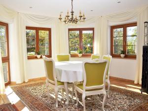 a dining room with a white table and chairs at Ferienhaus Zirbe in Rickenbach