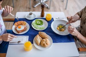 a group of people sitting at a table eating breakfast at IG Nachosol Atlantic & Yaizasol by Servatur - Adults Only in Puerto Rico de Gran Canaria