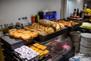 a display case with different types of donuts and pastries at IG Nachosol Atlantic & Yaizasol by Servatur - Adults Only in Puerto Rico de Gran Canaria