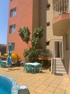 a patio with a table and chairs next to a building at Къща Нанси in Sunny Beach