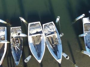 three boats are tied up in the water at Fairholme 5 in Tuncurry