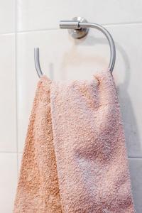 a towel hanging on a towel rack in a shower at Vista Mar e Terra in Albufeira