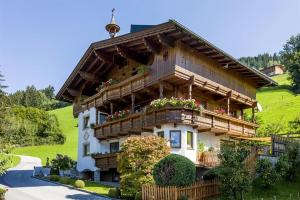 a house with flowers on the balcony of it at Haus Bergheim in Ramsau im Zillertal