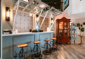 a bar with stools in a room at The Tudor in Ipoh