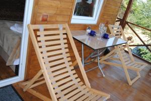 - une table et des chaises sur la terrasse couverte d'une cabine dans l'établissement Tsanava's cottage in Sighnaghi, à Sighnaghi
