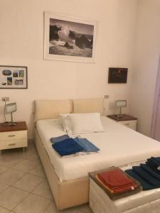 a bedroom with a bed and two tables and a picture at Via Cimarosa in Follonica