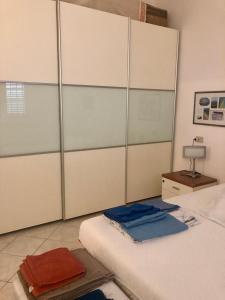 a bedroom with a bed and a large closet at Via Cimarosa in Follonica