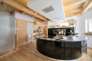 a kitchen with a large island in the middle of a room at Le relais de la Fis 6-14 pers in Chamonix