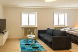 a living room with a couch and a bed at Modern Apartment in city center in Würzburg