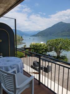 a balcony with a table and a view of a lake at Albergo Del Lago in Cannobio