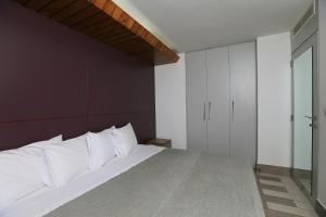a bedroom with a large bed with white pillows at Cimer SafraMarine Beach Resort in Safra