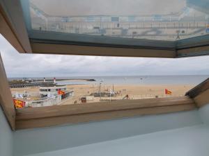 a view of the beach from the window of a building at Les Embruns in Trouville-sur-Mer