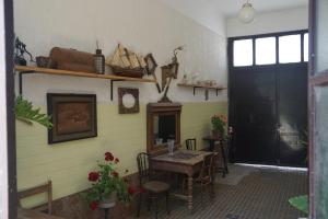 a room with a table and chairs and a fireplace at Somborski salas - strogi centar in Sombor