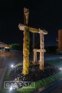 a statue of a cross at night at GarsON in Kŭrdzhali