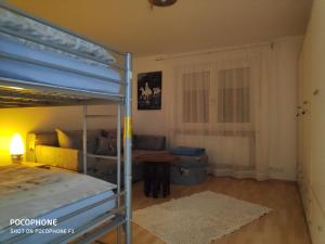 a bedroom with a bunk bed and a table at Ferienwohnung Allgäuglück in Waltenhofen