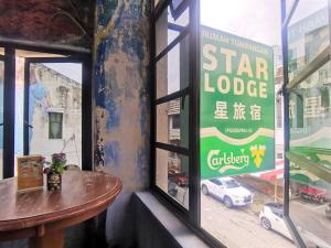 a sign in a window of a star lodge at Star Lodge in George Town