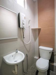 a bathroom with a toilet and a sink at Star Lodge in George Town +33 photos