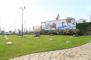 a park with rocks in the grass in front of a building at Cimer SafraMarine Beach Resort in Safra