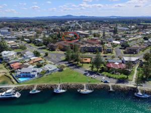 an aerial view of a resort with a red circle at St James 6 in Tuncurry