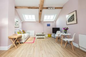 a living room with a couch and a table at The Hayloft, Wall End Farm in Leominster