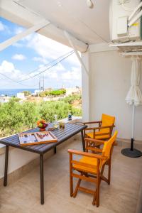 a dining room with a table and chairs and the ocean at Tranquility House in Livadia