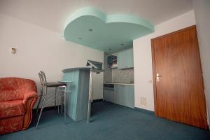 a kitchen with a table and a chair in a room at Hotel Cristal in Jupiter
