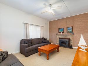 a living room with a couch and a fireplace at Wyvern in Forster