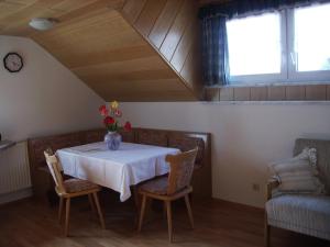 a dining room with a table and two chairs at Ferienwohnung Oswald in Isny im Allgäu