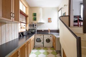 a kitchen with a washer and dryer in it at L'Esquisse by Cocoonr in Nantes