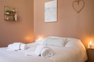 a bedroom with a white bed with two towels on it at L'Opéra - Bel appartement au pied du Capitole in Toulouse