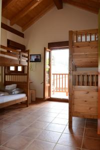 a room with two bunk beds and a sliding glass door at Albergue Usandi Auto Check-in in Ziortza-Bolibar