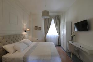 Postel nebo postele na pokoji v ubytování B&B Dimora del Duomo