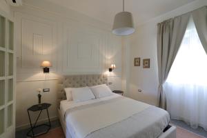 Postel nebo postele na pokoji v ubytování B&B Dimora del Duomo