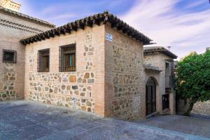 an old brick building with a tile roof at Casa de Bisagra in Toledo