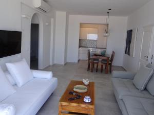 a living room with a white couch and a table at enJOY the sea and relax in Mikonos