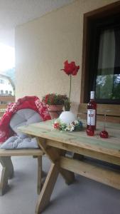 a wooden table with a flower on top of it at Haus Wastl in Russbach am Pass Gschütt