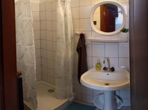 a bathroom with a sink and a mirror at Oázis Apartman in Szántód +18 photos