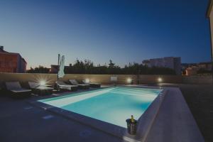 a swimming pool on the roof of a building at Poolside Hideout Apartments in Novalja