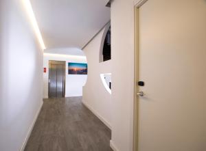 a hallway with white walls and a white door at Apartamentos Tramuntana in San Antonio
