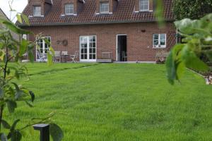 a house with a lawn in front of it at Maison Margriet in Tongeren