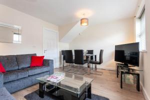 a living room with a couch and a table at Executive St Marys House in Warrington