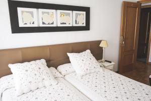 レルマにあるPiso turístico Belisaのベッドルーム1室(白いシーツと枕のベッド1台付)