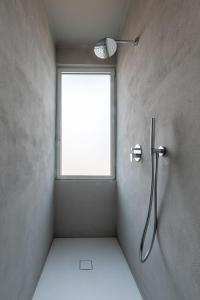 a bathroom with a shower with a window at Suites Menaggio in Menaggio