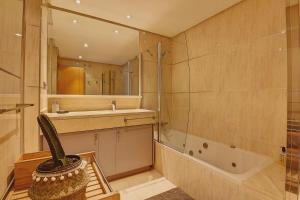 a bathroom with a sink and a mirror and a cactus at La Sal in Tazacorte +14 photos