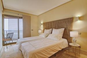 a bedroom with a large bed and a balcony at La Sal in Tazacorte