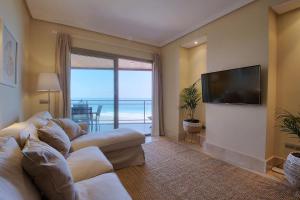 a living room with a couch and a flat screen tv at La Sal in Tazacorte