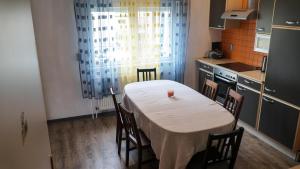 a kitchen with a table with a white table cloth at Ljubljana apartment in Ljubljana
